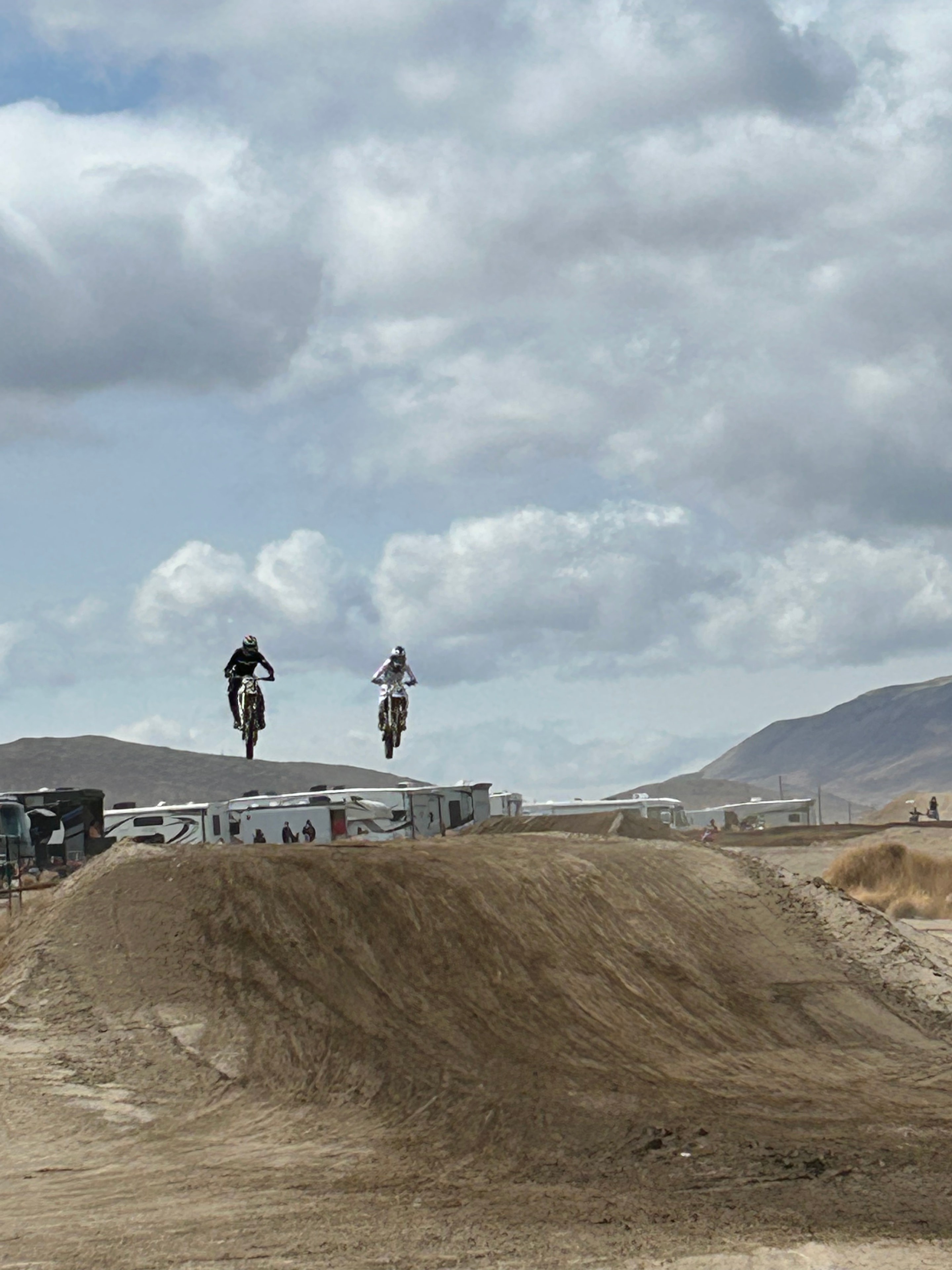 Family motocross riding action — Amped Trail Company guides on track