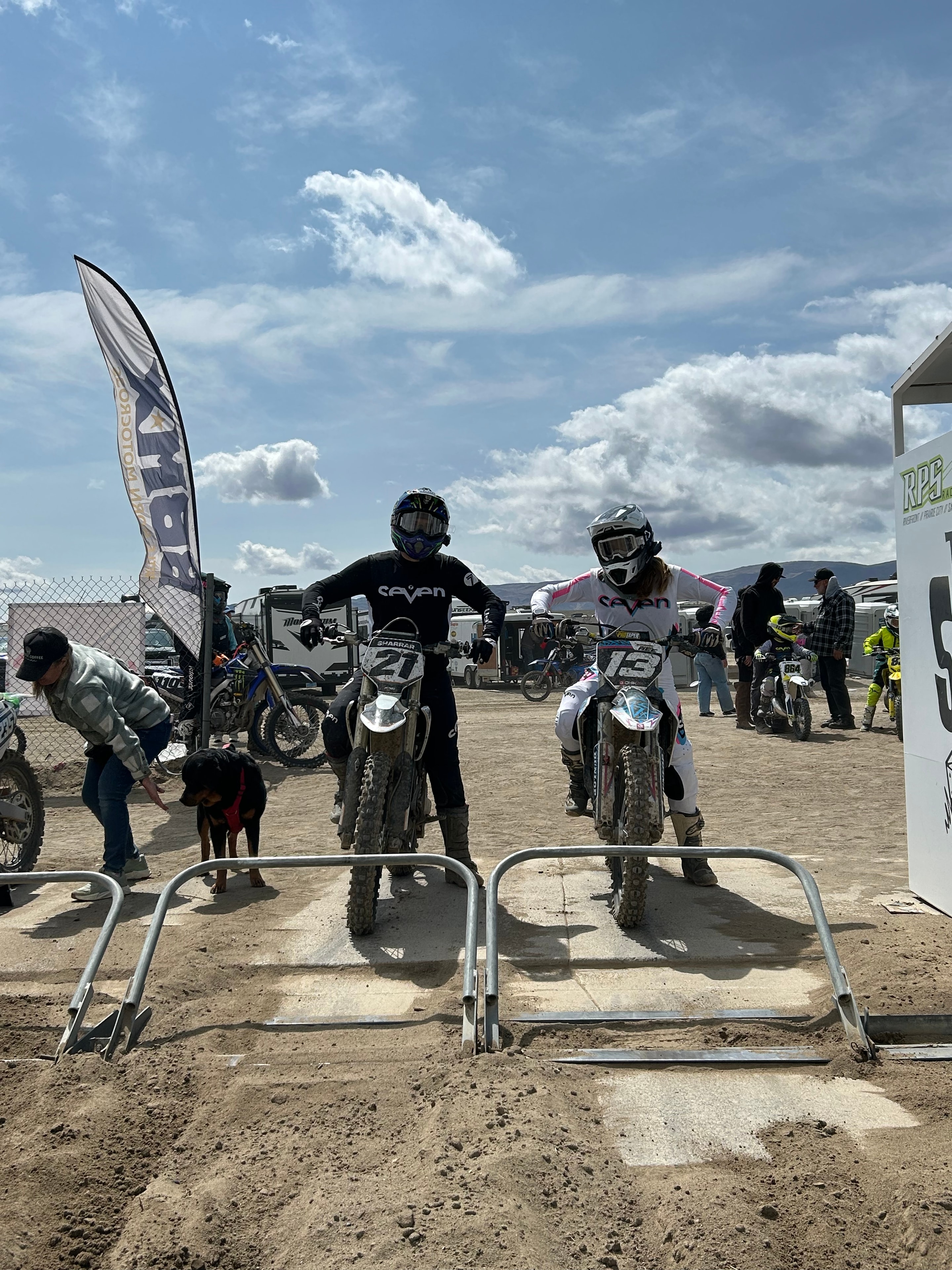 Trail Boss and Throttle Belle at a motocross event — the Amped Trail Company guide team